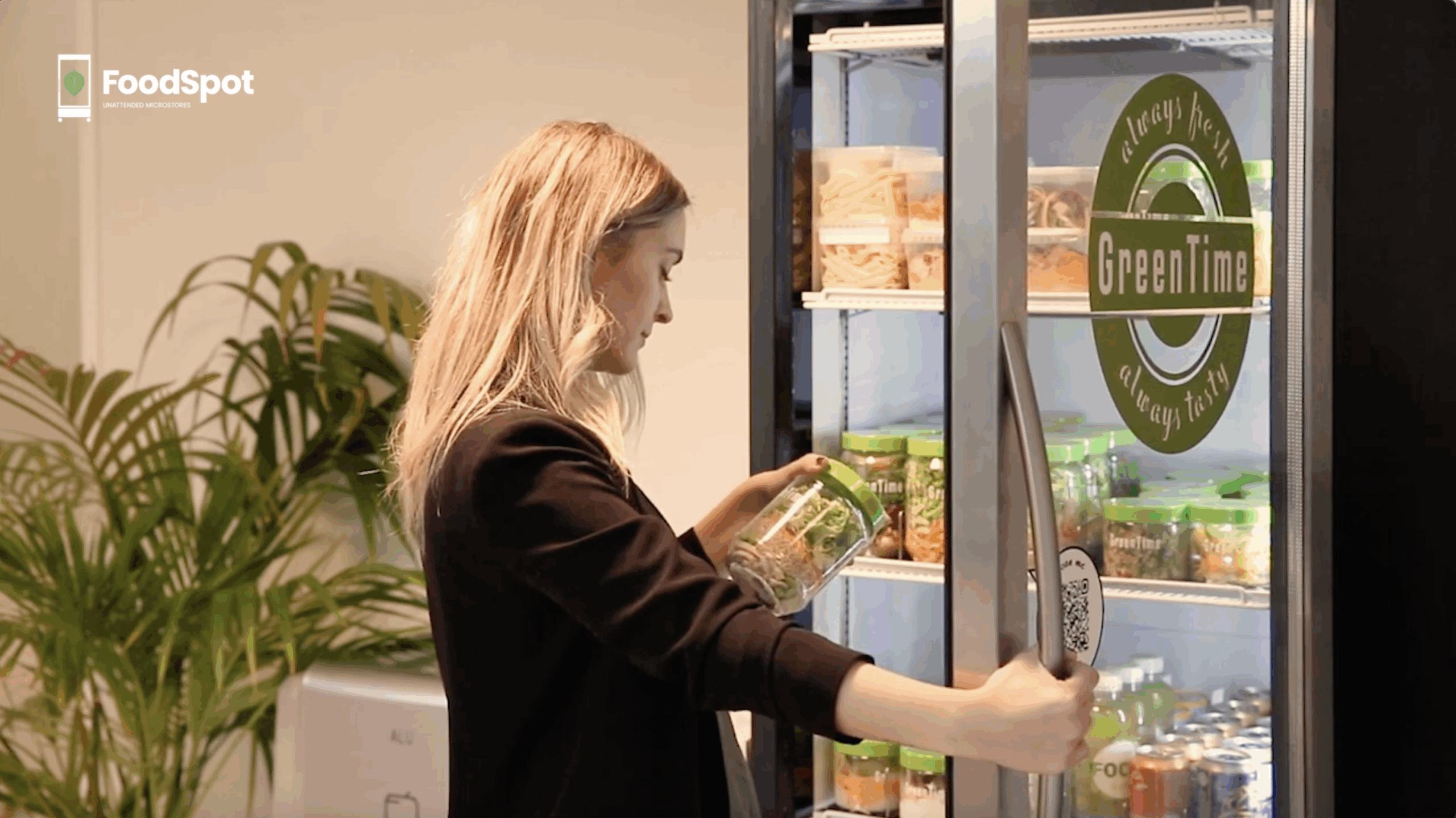 woman grabbing salad out of a smart cooler