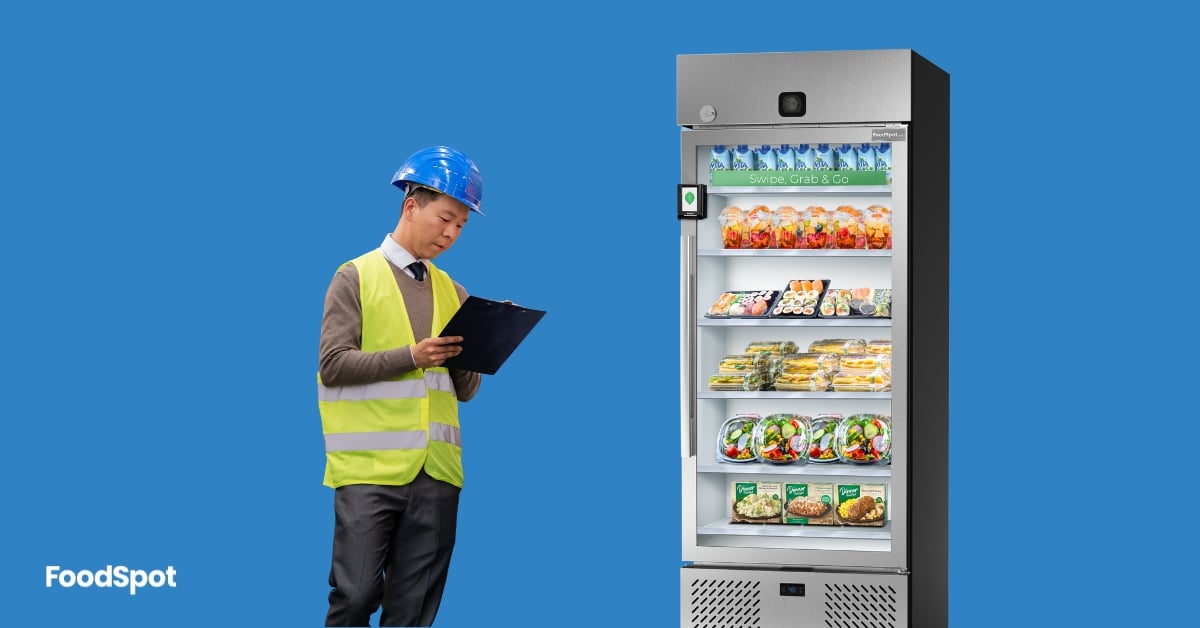 man with clip board standing by smart fridge vending machine