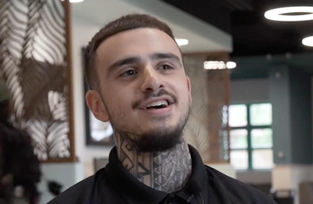 young man smiling at camera in corporate breakroom