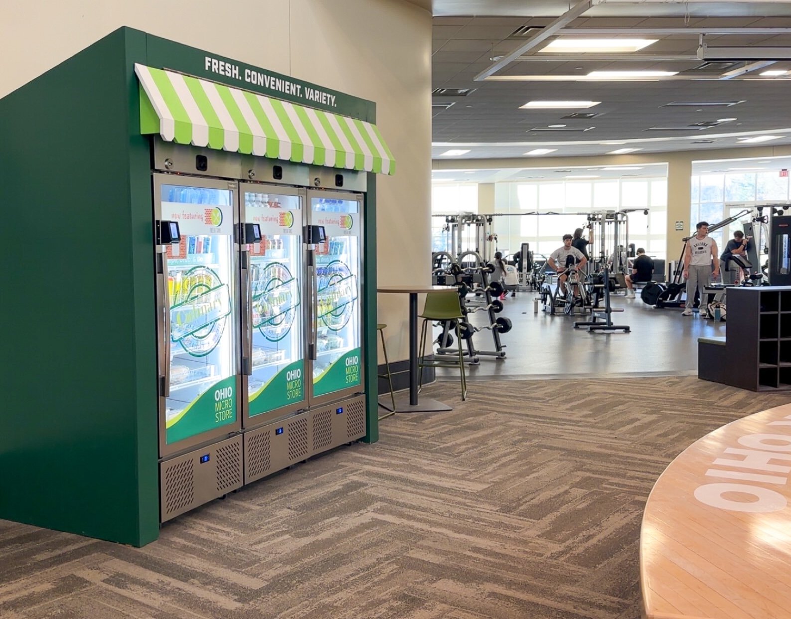 three smart fridge microstores in a gym