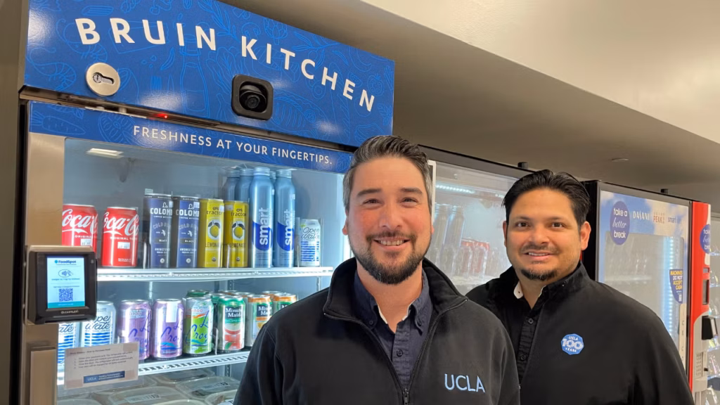 two men standing in front of smart fridge microstore